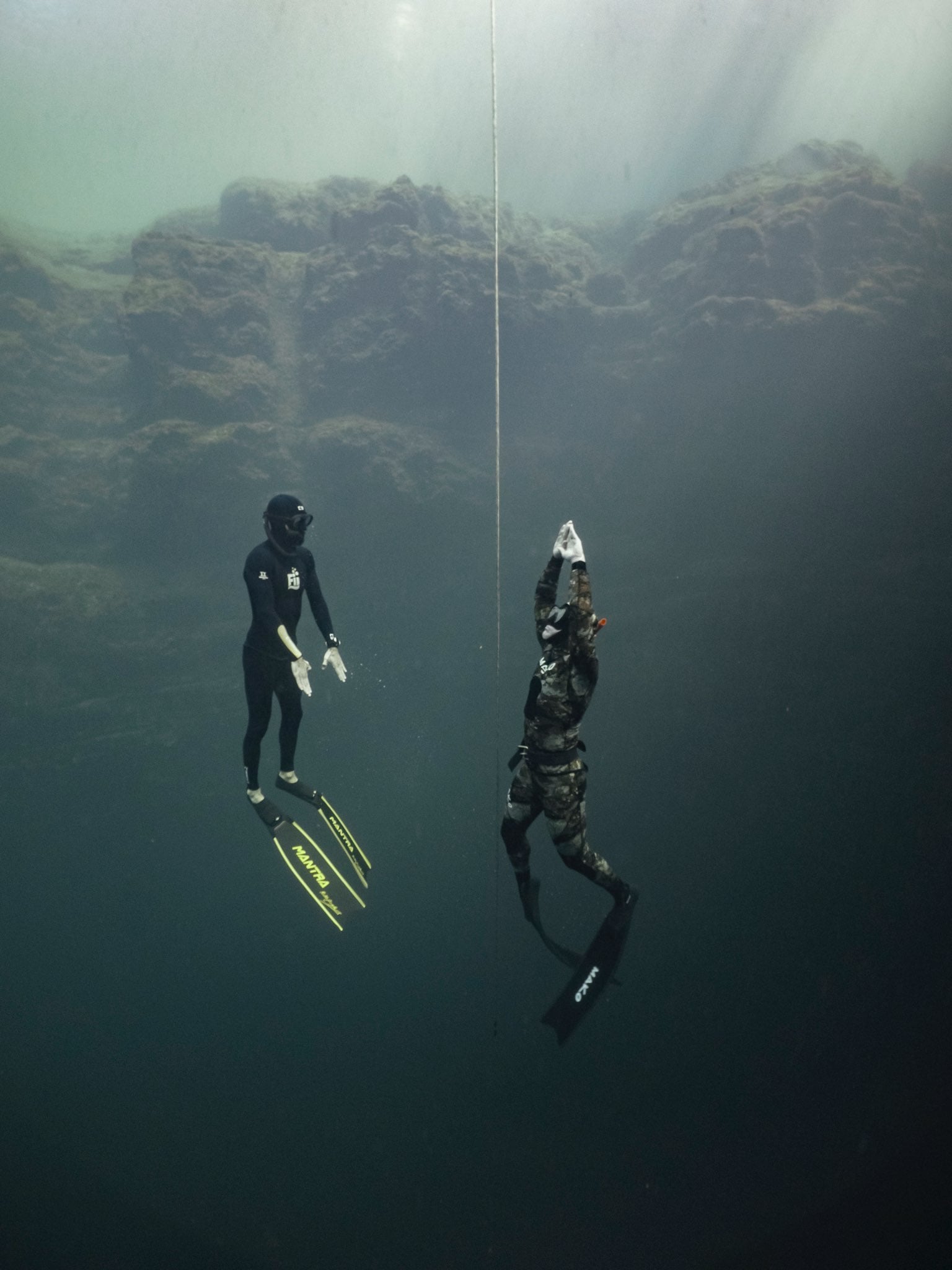 A student ascending the line from 20 meters, the safety diver beside him